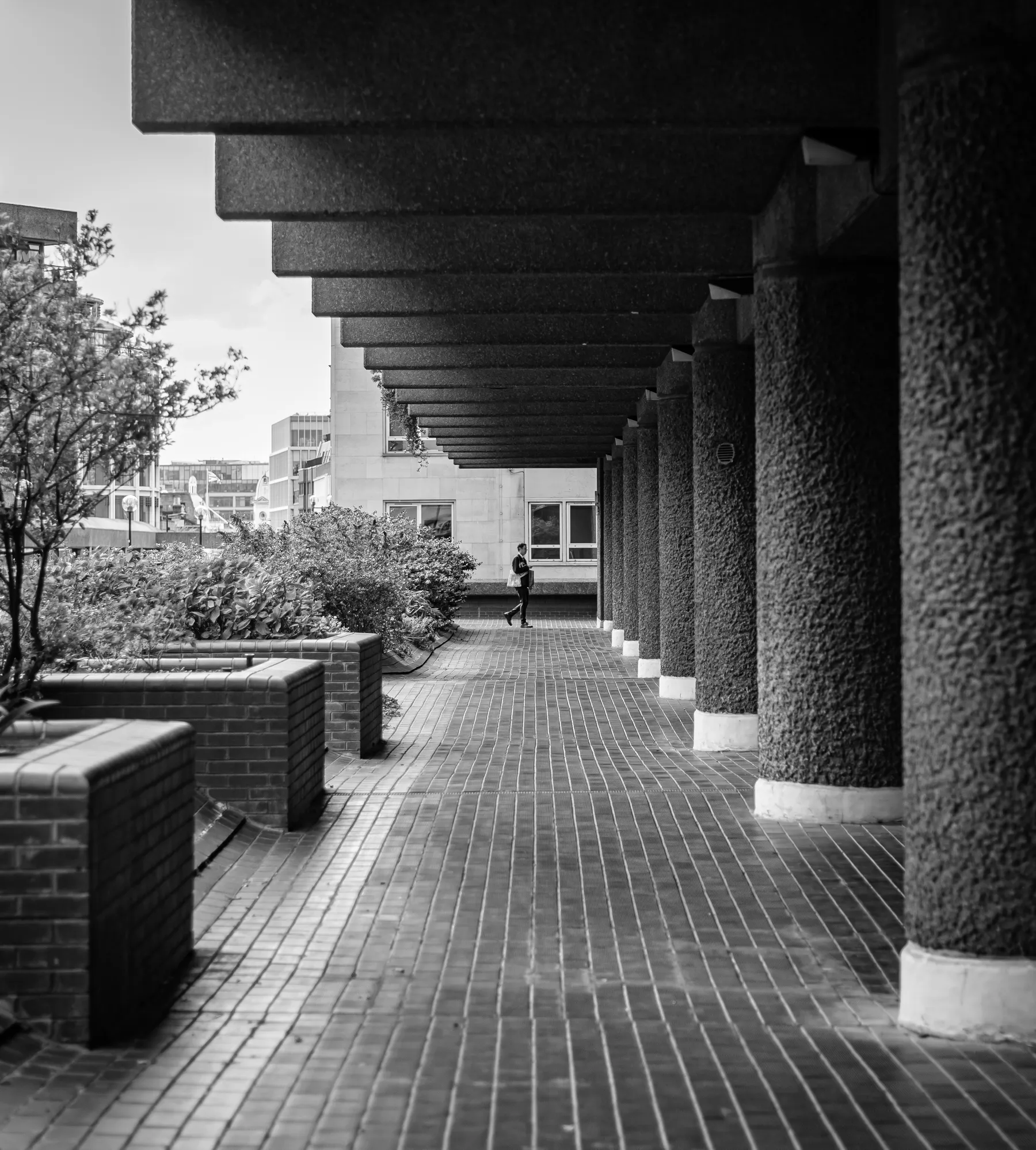 Man walking along podium in the Barbican